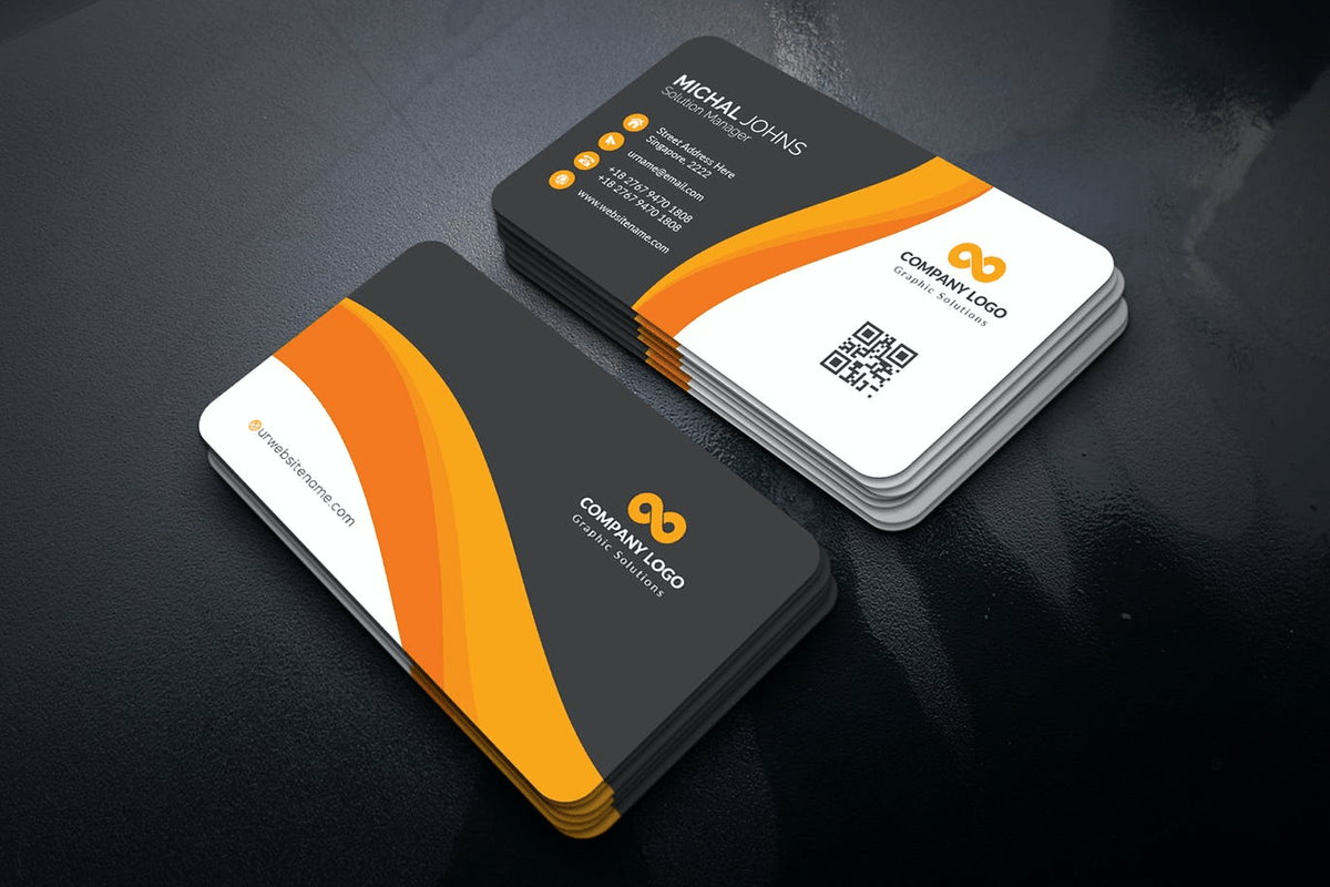 Stacks of printed rounded-corner business cards showing the front and back design